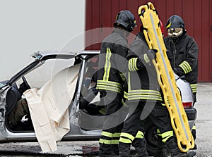 firefighters at the rescue to the injured with a yellow stretche