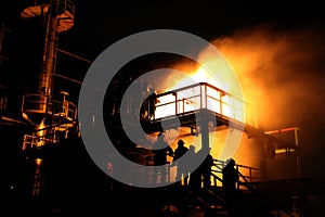 Firefighters and rescue training. Firefighter spraying high pressure water to fire Burning fire flame background.