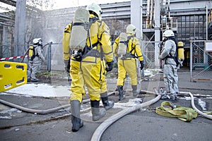 Firefighters and rescuers in a radiation protection, chemical protection suit