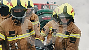 Firefighters rescuing injured person after the car accident. Slow motion