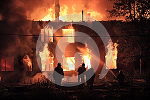 Firefighters silhouettes on fire background