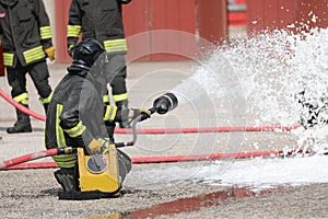 firefighters with the special flame retardant foam extinguish a