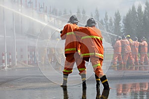 Firefighters spray water in fire extinguishers caused by explosive gas