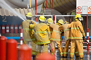 Firefighters spray water in fire extinguishers caused by explosive gas