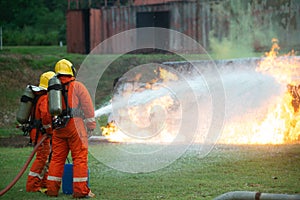 Firefighters spraying water to put out a brutal fire on the truck.