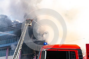 Firefighters on stairs extinguish a big fire