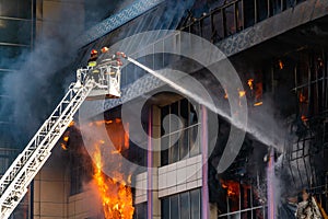 Firefighters on stairs extinguish a big fire