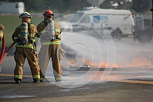 Firefighters train on extinguishing fuel spill fire.