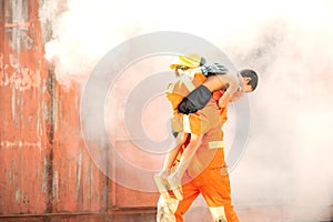 Firefighters training activity, Team practice to fight fire in emergency situation. A fireman run out with children from burning