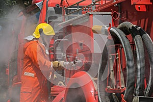 Firefighters training Team practice to fighting with fire in emergency situation. A fireman attach hose to fire fighter vehicle