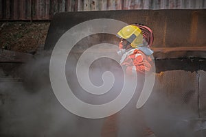 Firefighters training,Team practice to fighting with fire in emergency situation. A fireman attach hose to fire fighter vehicle