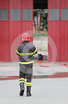 Firefighters in uniform with red helmet