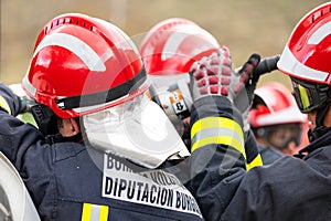 Firefighters using hydraulic tools during a rescue operation training. Rescuing the passenger in car after accident.