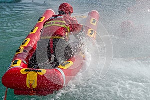 Firefighters in water rescue drill, using canoe and special suits. Aerial view from drone