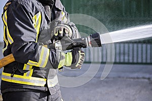 Firefighters who use fire extinguishers and hose water to fight fires