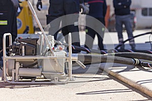 Firefighters working with a suction pump
