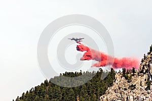 Firefighting aircraft dumping retardant photo