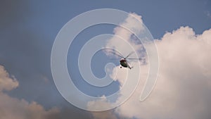 Firefighting helicopter flying over smoke