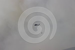 Firefighting helicopter high up in the air