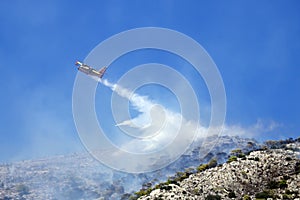 Firefighting plane extinguishes a fire on the hillside . Greece.