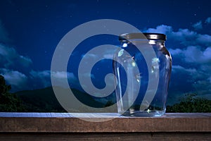 Fireflies in a jar at night