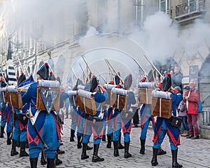 Firegun shots fired by soldiers on traditional costume during a Parade on Zibelemarit Holiday Onion Market - Bern, Switzerland