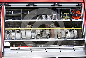 Firehoses and other tools in a truck to be used by firefight.