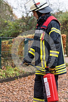 Fireman in action with a fire extinguisher