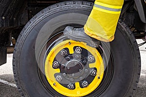 Fireman boot standing on large wheel.