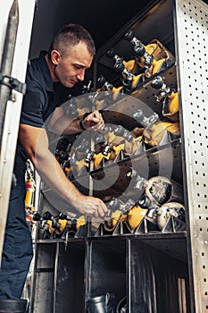 Fireman checking fire extinguisher in truck