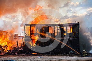 Fireman extinguishes a burning house