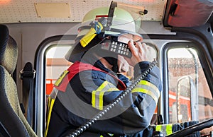 Fireman in a fire truck drived and spark with radios set