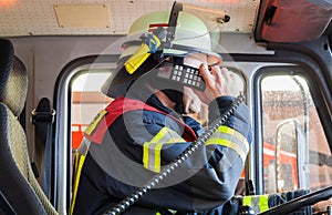 Fireman in a fire truck drived and spark with radios set photo