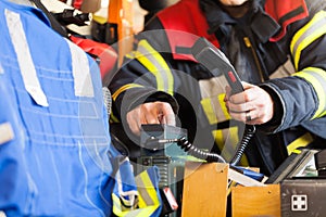 Fireman in a fire truck spark with radios set photo