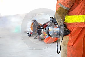 Fireman hand in glove hold oxygen mask