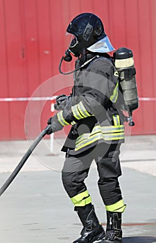 fireman with hardhat and oxygen cylinder with respirator