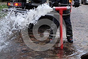 The fireman opens a fire hydrant