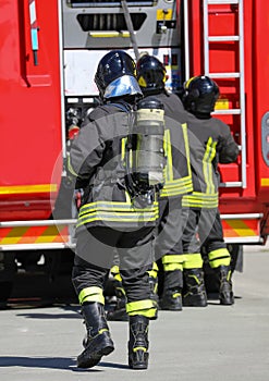 Fireman with oxygen tank and fire truck in the background