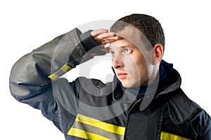 Fireman in protective suit looks off into the distance