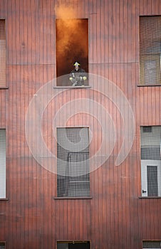 Fireman protrudes from a window
