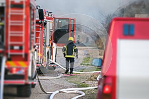 fireman rescuing a burning house