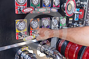 Fireman`s hand  pulling valave on a fire engine