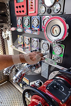 Fireman`s hand  pulling valave on a fire engine