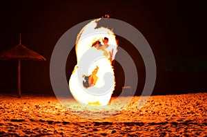 Fireman Show on the beach dance man juggling with swing fire spa