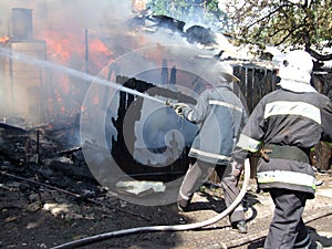 fireman spraying water firefighters extinguish a fire in an apartment house