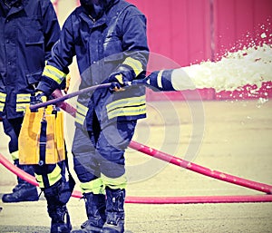fireman sprays foam from a pump