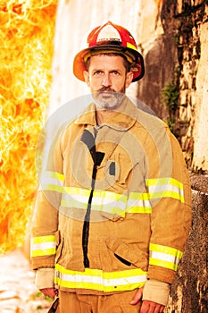 Fireman standing in front of wall of fire