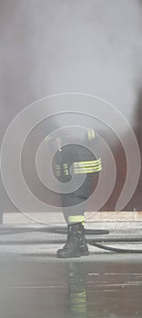 fireman uses a foam to extinguish a fire