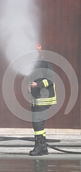 fireman uses a nebulized foam to extinguish a big fire