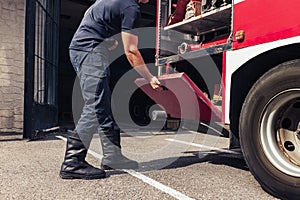 Fireman working with firefighting truck full of resque equipment